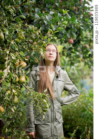 Portrait of a teenage girl near a pear tree 119035989