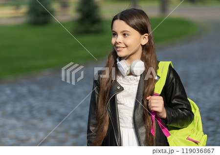 Teen girl school student outdoor. Copy space. Student life. Listen to music in headphones. Teen girl generation. Lifestyle and education. Back to school. School education. Adolescence lifestyle Teen girl school student outdoor. Copy space. Student life. Listen to music in headphones. Teen girl generation. Lifestyle and education. Back to school. School education. Adolescence lifestyle 119036867