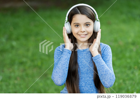 School student lifestyle. Listen audio. Music lifestyle. Teen girl listen music in wireless headphones outdoor. Gen z lifestyle. Style of music. Stylish teen girl listen music. Copy space 119036879