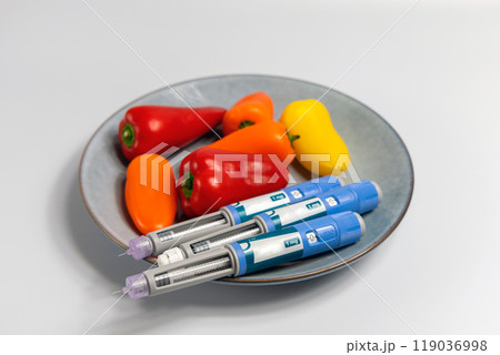 Ozempic Insulin injection pen for diabetics and weight loss and plate of vegetables 119036998