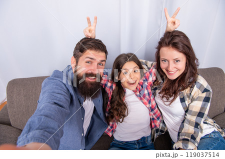 mom dad and daughter love relax together. adoption and charity. family day. friendship. mom dad and daughter love relax together. adoption and charity. family day. friendship. 119037514