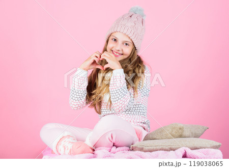 Prevent winter hair damage. Winter hair care tips you should follow. Child long hair smiling show heart gesture. Girl wear knitted hat pink background. Look after scalp and hair this winter Prevent winter hair damage. Winter hair care tips you should follow. Child long hair smiling show heart gesture. Girl wear knitted hat pink background. Look after scalp and hair this winter 119038065