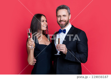 positive couple cheering and celebrate isolated on red. couple cheering and celebrate in studio. positive couple cheering and celebrate isolated on red. couple cheering and celebrate in studio. 119038187