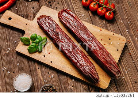 Dry-cured salami on board, ideal for rustic charcuterie presentations and gourmet food styling 119038261