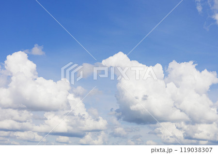 The sky is a beautiful shade of blue adorned with white clouds in it The sky is a beautiful shade of blue adorned with white clouds in it 119038307