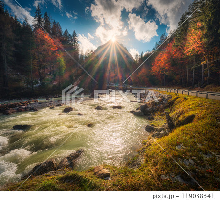 River, trees with red leaves and mountain at sunset in autumn 119038341