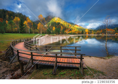 Mountain lake, colorful trees and wooden bridge in autumn Mountain lake, colorful trees and wooden bridge in autumn 119038356