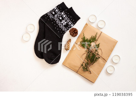 New year 2020 flat lay.Christmas black ornamental socks,gift box in eco kraft paper with pine tree cones.Winter holidays 119038395