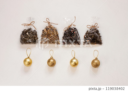 New year flat lay. Christmas tea gift box wrapped in kraft paper with pine tree cones.Mockup template. Winter holidays 119038402