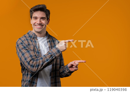 Recommending smiling man pointing at right side, copy space or advertising. 119040398