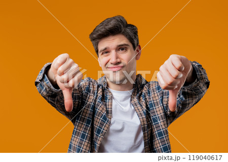 Adult 30s man with sign of dislike. European guy expressing thumbs-down,negative 119040617