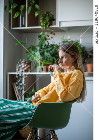 Thoughtful tired female holding smartphone puzzled of received unhappy news, planning future actions 119040919