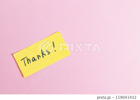 Yellow small note with the word thank you on a pink background in the center Yellow small note with the word thank you on a pink background in the center 119041432