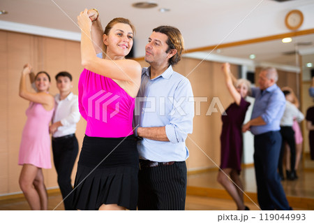 Woman and man practicing bachata in dance class 119044993