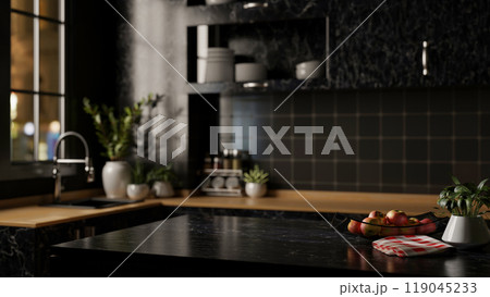 A modern black marble kitchen island designed for displaying products in a sleek black kitchen. 119045233