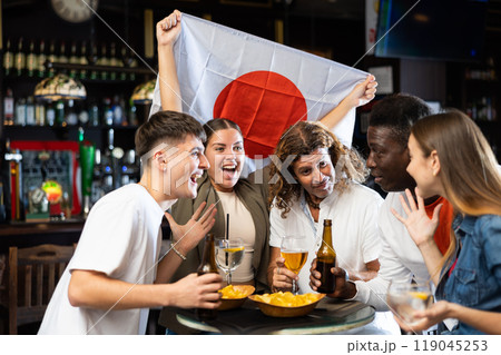Men and women supporting Japan sports team in pub Men and women supporting Japan sports team in pub 119045253