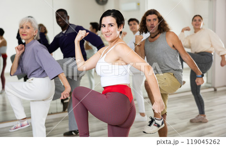 Happy Latina enjoying active dancing during group training Happy Latina enjoying active dancing during group training 119045262