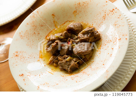 Lamb stew with garlic shoots seasoned with smoked paprika Lamb stew with garlic shoots seasoned with smoked paprika 119045773