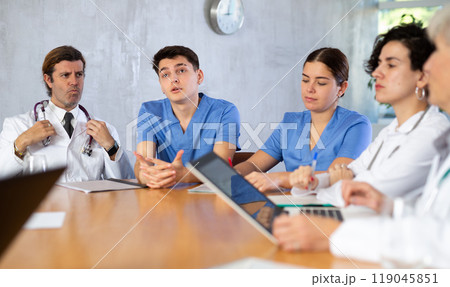 Medical director holds a meeting with colleagues in the office of clinic Medical director holds a meeting with colleagues in the office of clinic 119045851