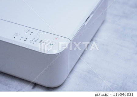 White printer for printing and scanning documents, close-up on a marble table. White printer for printing and scanning documents, close-up on a marble table. 119046831