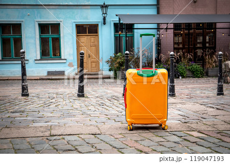 Travel suitcase on the street. Old town and historical buildings. Travel concept 119047193
