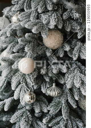 Christmas tree with many ornaments on it Christmas tree with many ornaments on it 119050993