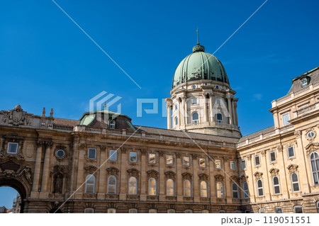 Budapest, Hungary. August 26, 2022. Shot with the big green dome of the Buda Castle sticking out over the building. Budapest, Hungary. August 26, 2022. Shot with the big green dome of the Buda Castle sticking out over the building. 119051551