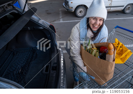 Woman uploading Groceries into Car Woman uploading Groceries into Car 119053156