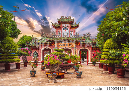Beautiful ancient Asian gate to the Hoi Quan Phu Kien Buddhist pagoda with a temple in old town in Hoi An in Vietnam in Asia at sunset 119054126