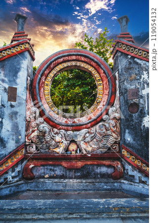 Beautiful Ancient Asian gate to Buddhist pagoda in Hoi An old town in Vietnam in Asia at sunset 119054132