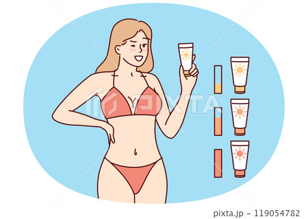 Woman in beach tanning bikini demonstrates anti-sunburn cream for visiting solarium 119054782