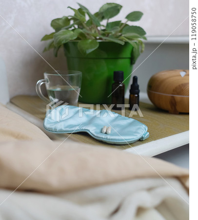 A woman cannot fall asleep and wants to drink a capsule with melatonin, a sleeping pill. Manifestations of jitlag or insomnia. Regulation of biological rhythms 119058750