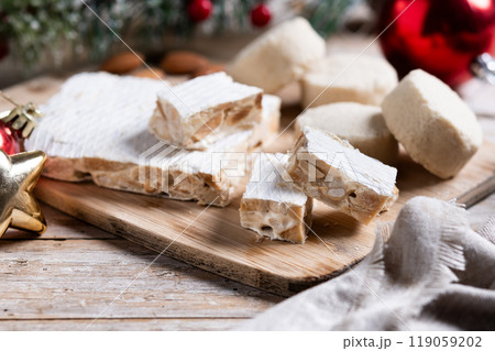 Christmas almond nougat and shortbread on wooden table Christmas almond nougat and shortbread on wooden table 119059202