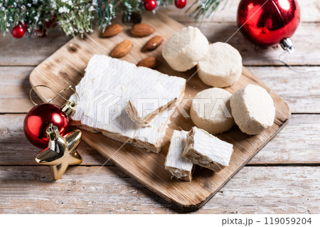 Christmas almond nougat and shortbread on wooden table 119059204