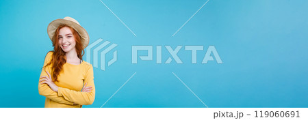 Travel concept - Close up Portrait young beautiful attractive redhair girl wtih trendy hat and sunglass smiling. Blue Pastel Background. Copy space 119060691