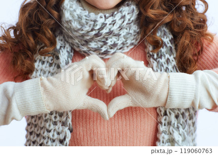 Modern 40 years old woman showing heart hands on white 119060763