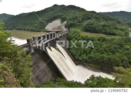 豪雨の後の茶色い水を吐き出すダム 豪雨の後の茶色い水を吐き出すダム 119060782