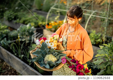 Young Woman with Harvest Basket in Garden Young Woman with Harvest Basket in Garden 119062688