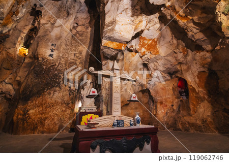 Buddhist statue scales inside Asian sacred temple in the Am Phu Cave in the Marble Mountains in Da Nang in Vietnam in Asia Buddhist statue scales inside Asian sacred temple in the Am Phu Cave in the Marble Mountains in Da Nang in Vietnam in Asia 119062746