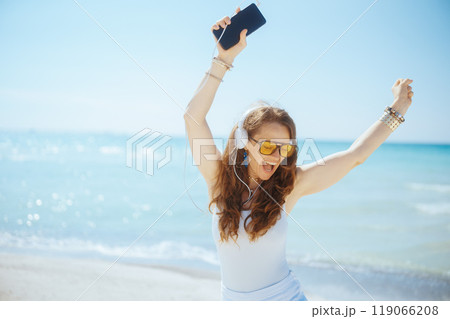 smiling elegant woman on seacoast dancing smiling elegant woman on seacoast dancing 119066208