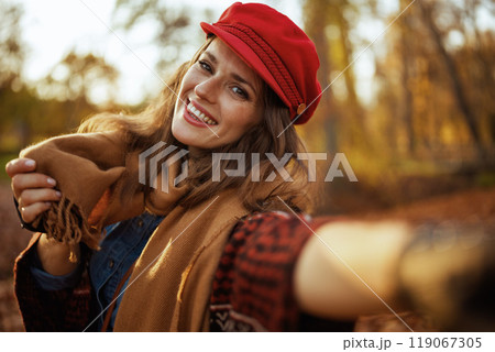 happy modern female in red hat having web cam meeting happy modern female in red hat having web cam meeting 119067305
