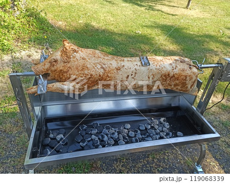 Enjoy a Whole Pig Roasting on a Spit for a Memorable Outdoor Barbecue Event Experience Enjoy a Whole Pig Roasting on a Spit for a Memorable Outdoor Barbecue Event Experience 119068339