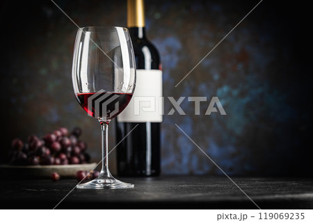 Red Wine in a Glass with Bottles and Grapes Red Wine in a Glass with Bottles and Grapes 119069235
