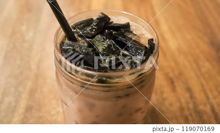 Ice milk cincau is a traditional cold beverage from Indonesia or iced grass jelly with milk and brown sugar. Ice milk cincau is a traditional cold beverage from Indonesia or iced grass jelly with milk and brown sugar. 119070169