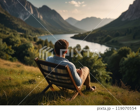 sitting man relaxes against a beautiful natural landscape 119070554