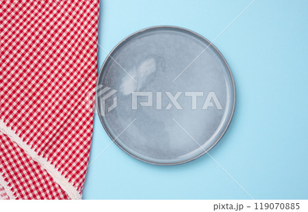 Round ceramic empty blue plate and red kitchen towel Round ceramic empty blue plate and red kitchen towel 119070885