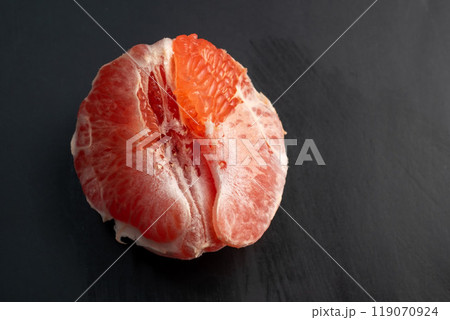 Juicy red grapefruit on black background 119070924