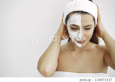 Cosmetology theme. Girl in a white bandage. Woman with mask on face. 119071537