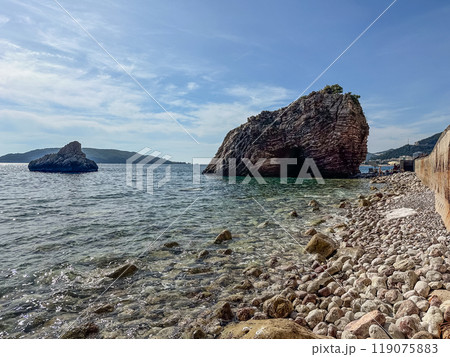 Large rock in the sea at sunny day 119075883