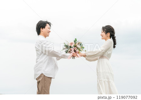 ブーケを渡す新郎と受け取る新婦・カジュアルウェディング・カップル・恋人・夫婦のイメージ 119077092